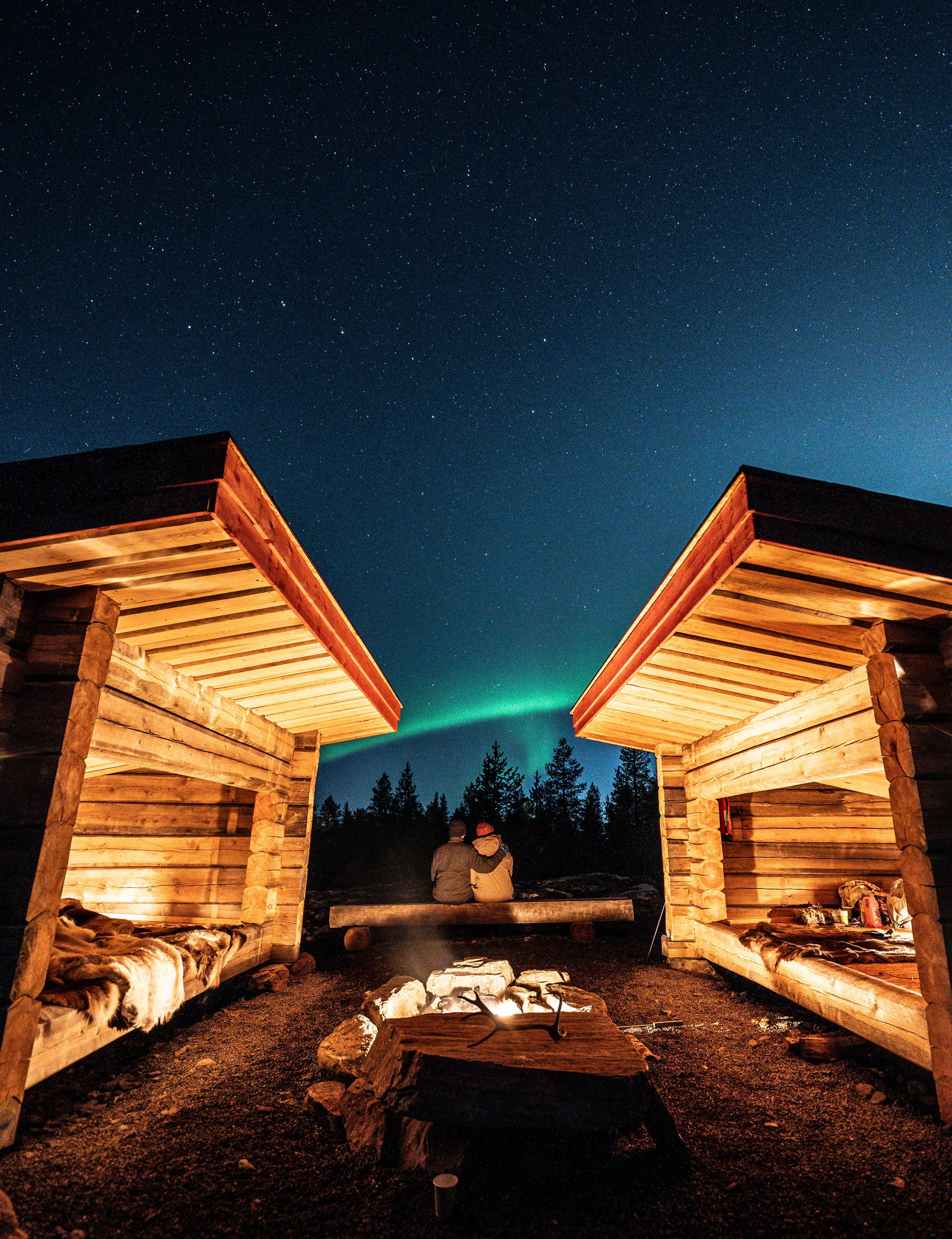 Watching the Northern Lights from a campfire on a reindeer pasture in Rovaniemi