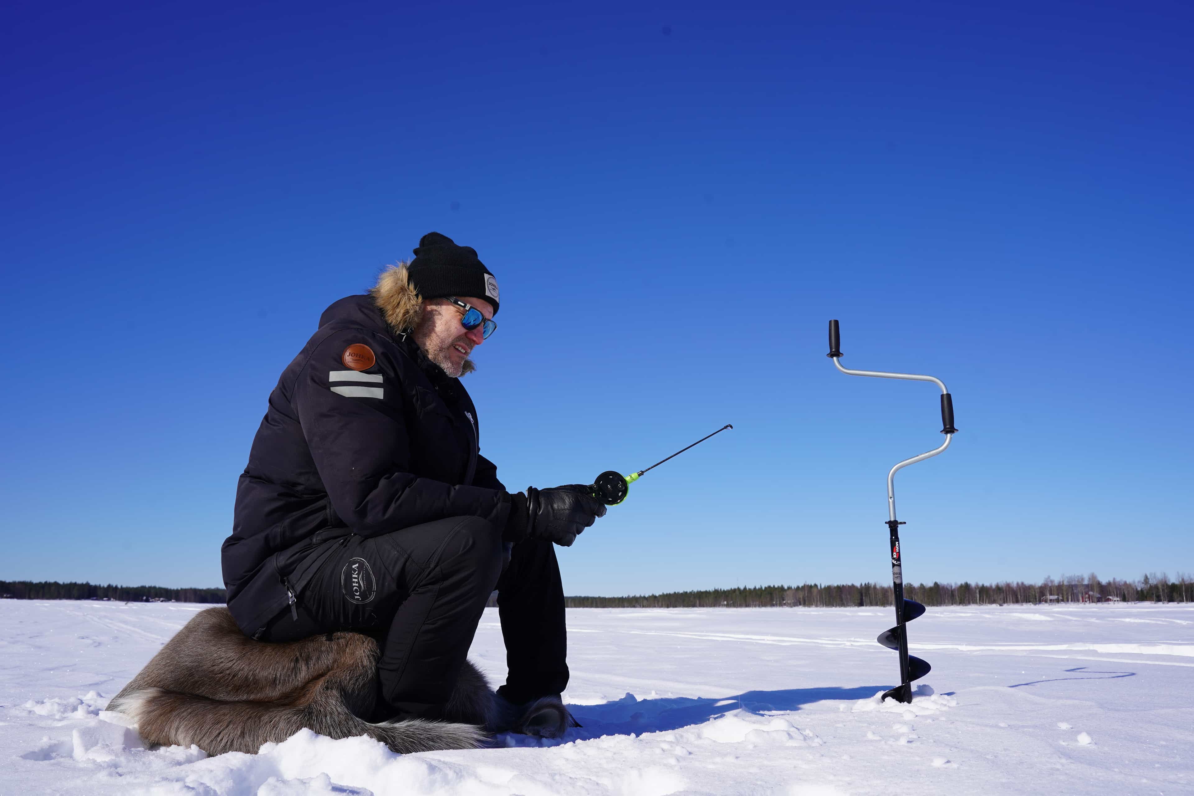 Ice Fishing Experience by the lake, Rovaniemi, Lapland, Finland