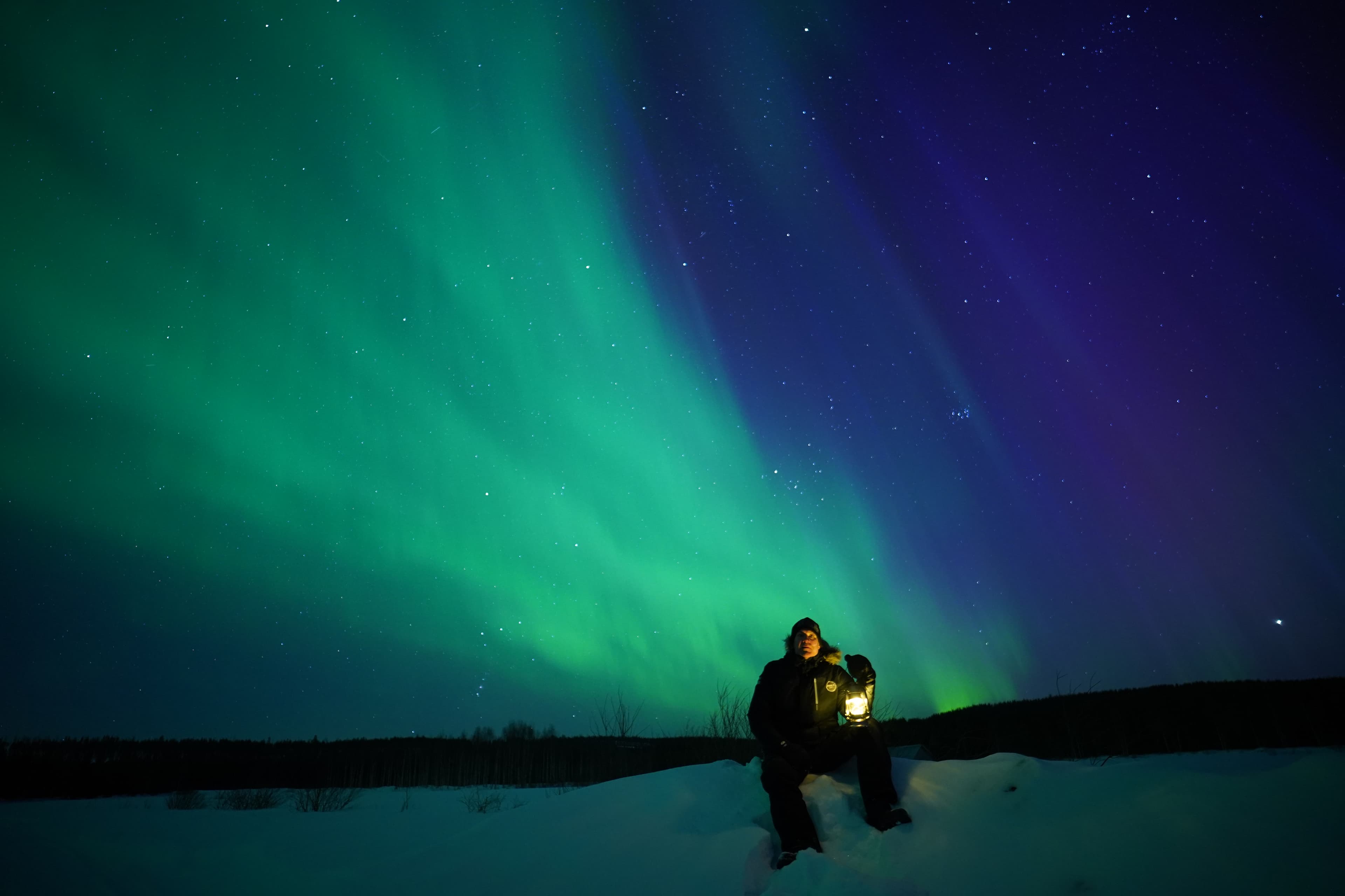 Northern lights picnic by the lake, Rovaniemi, Lapland, Finland